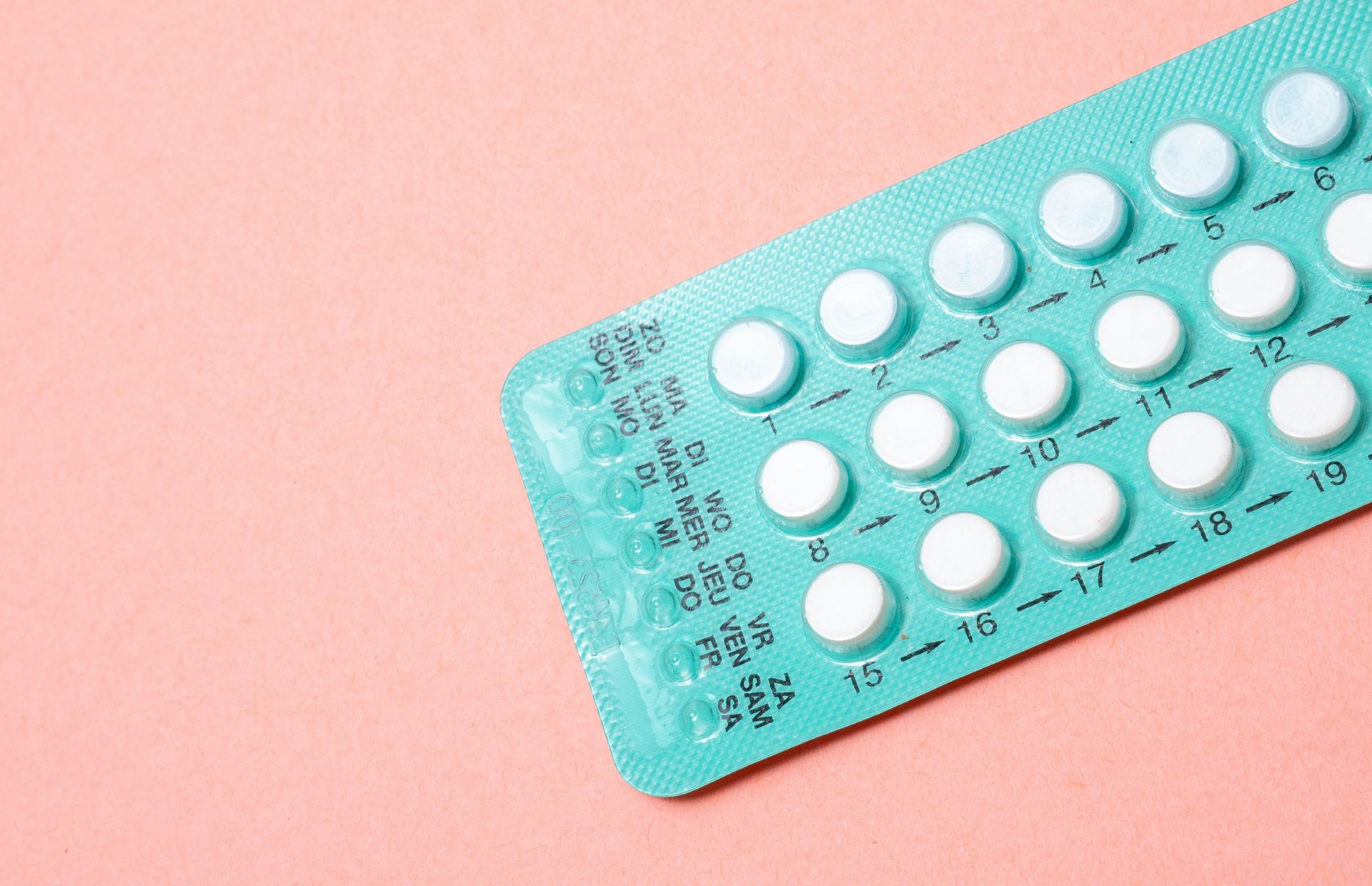 A pack of the contraceptive pill on a pink background