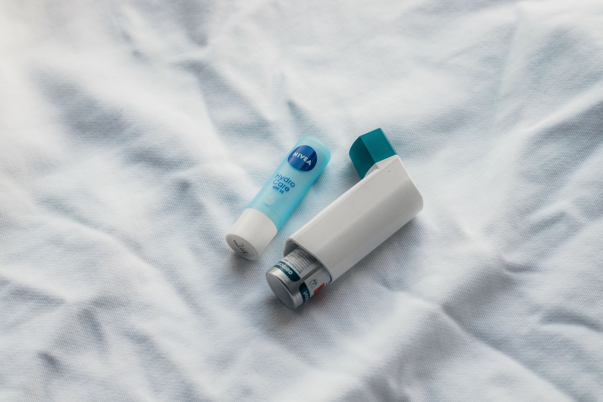 two inhalers on a white sheet
