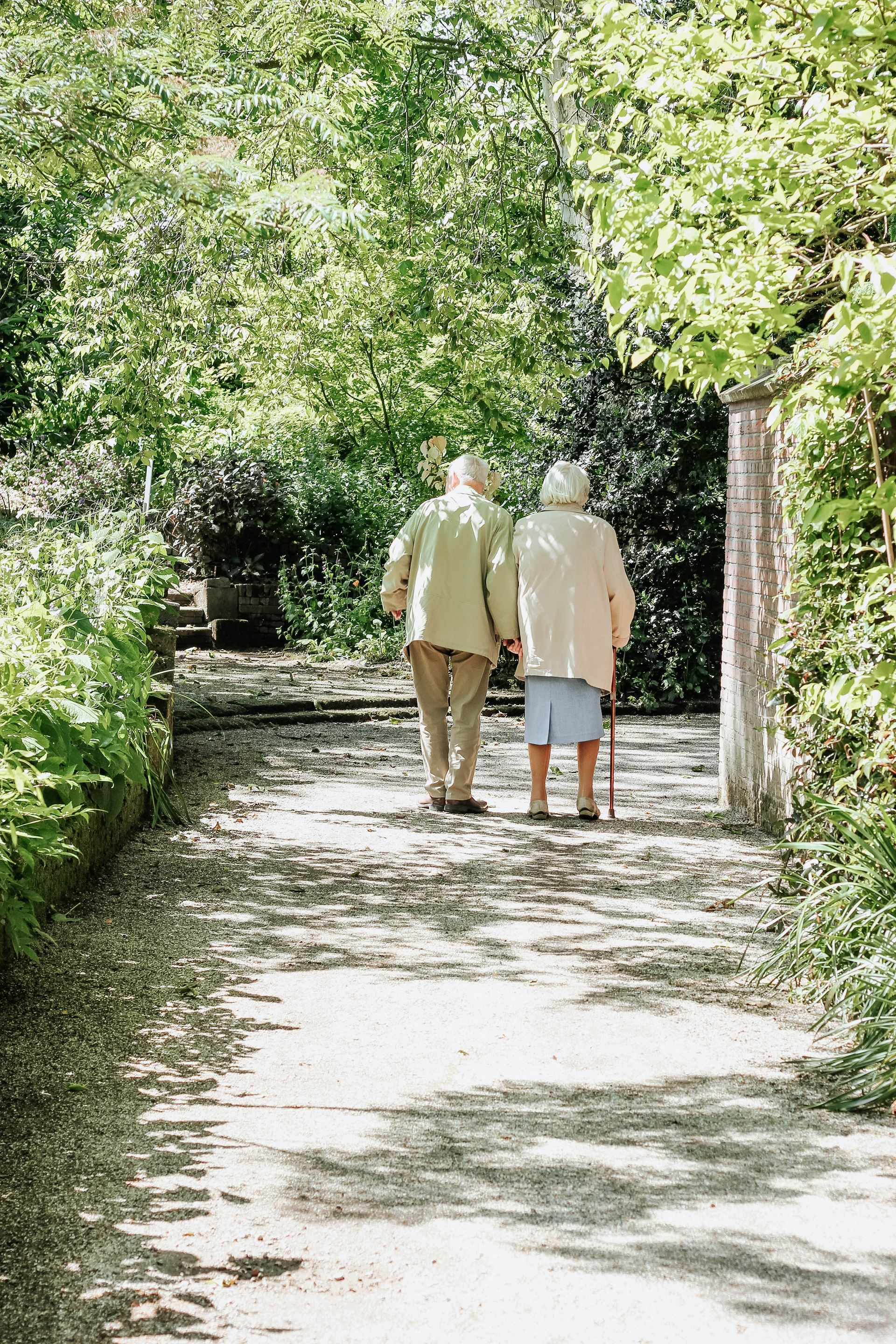 An older couple walking together in a park