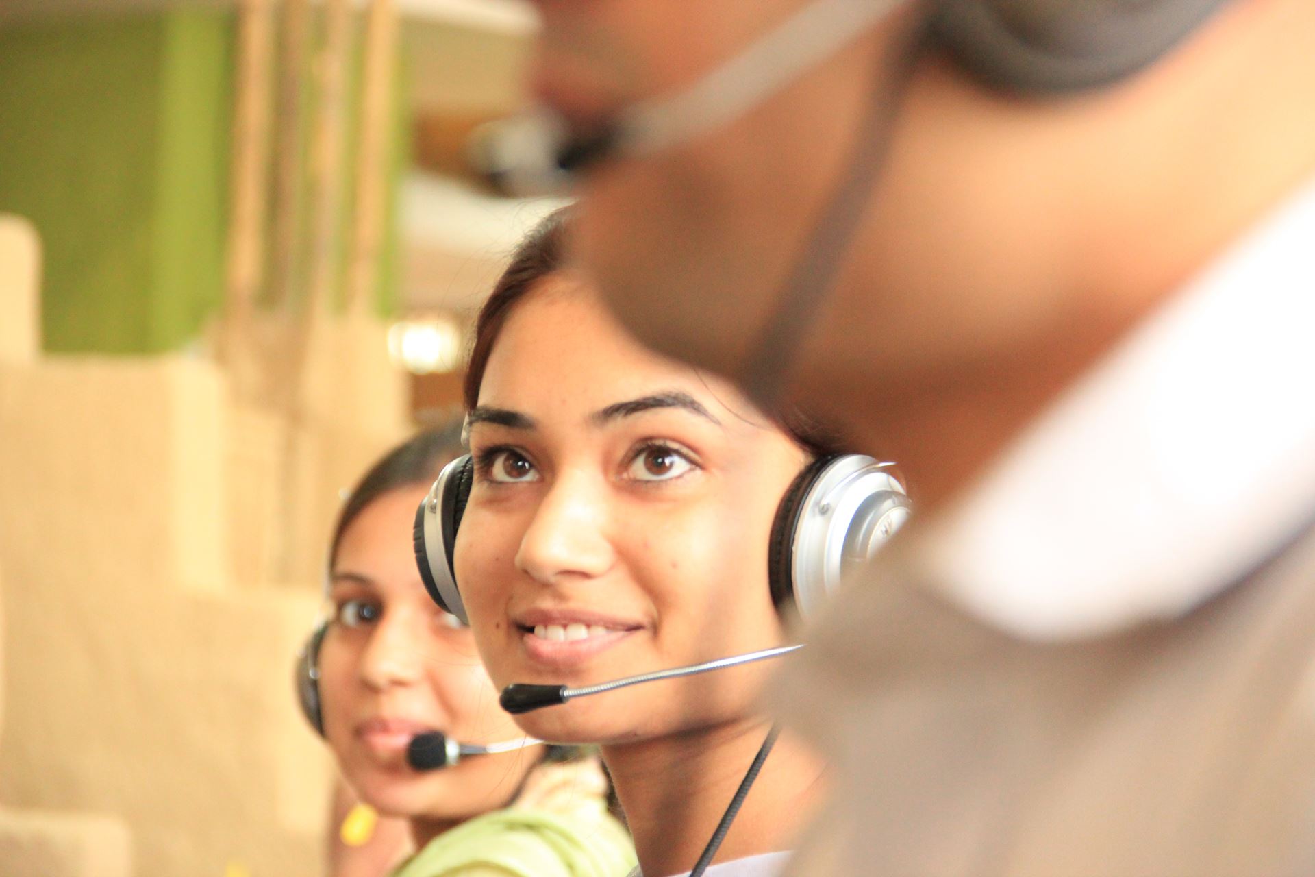 A lady in a call centre wearing a headset