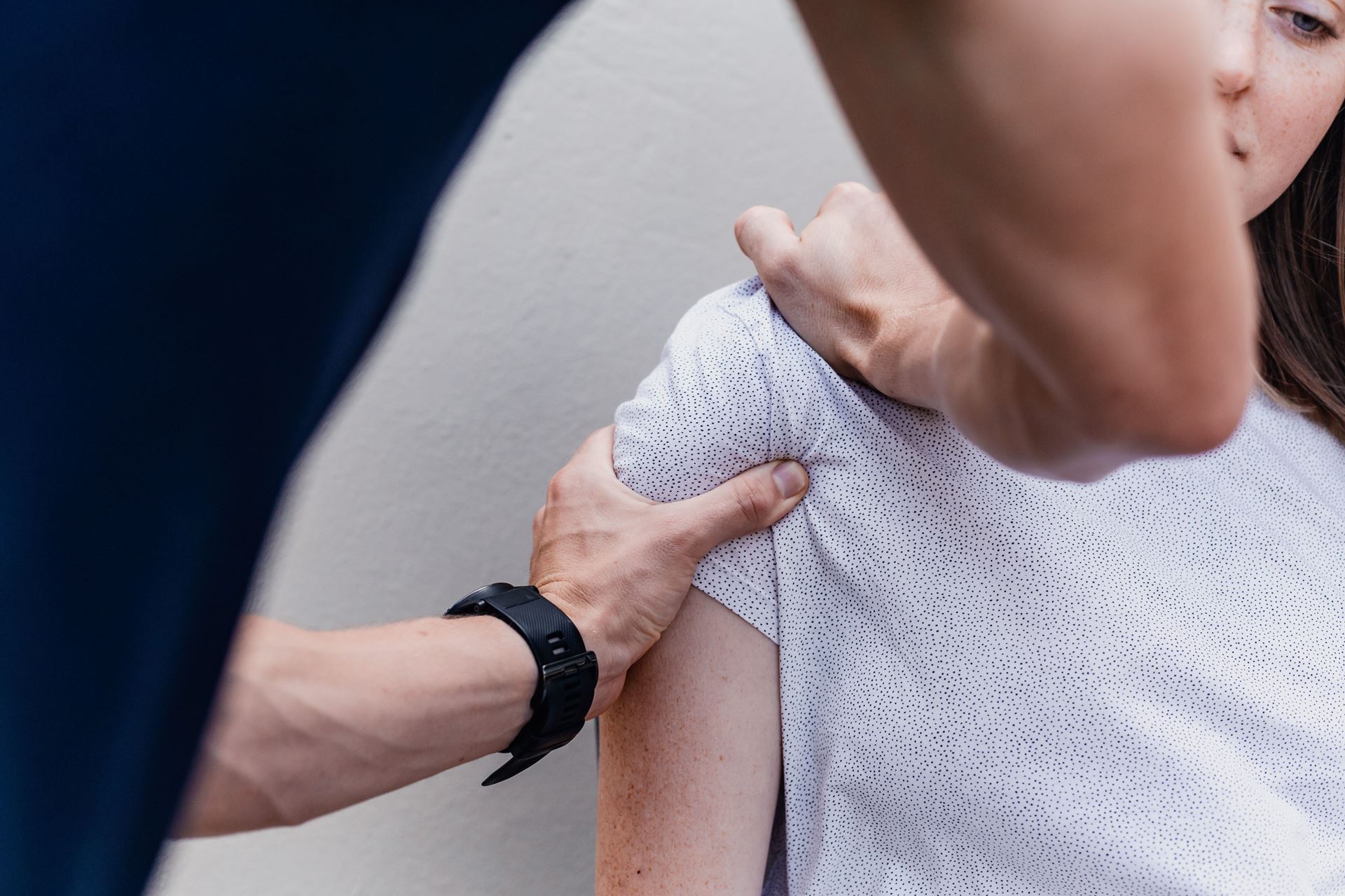 A physiotherapist manipulating someone's shoulder